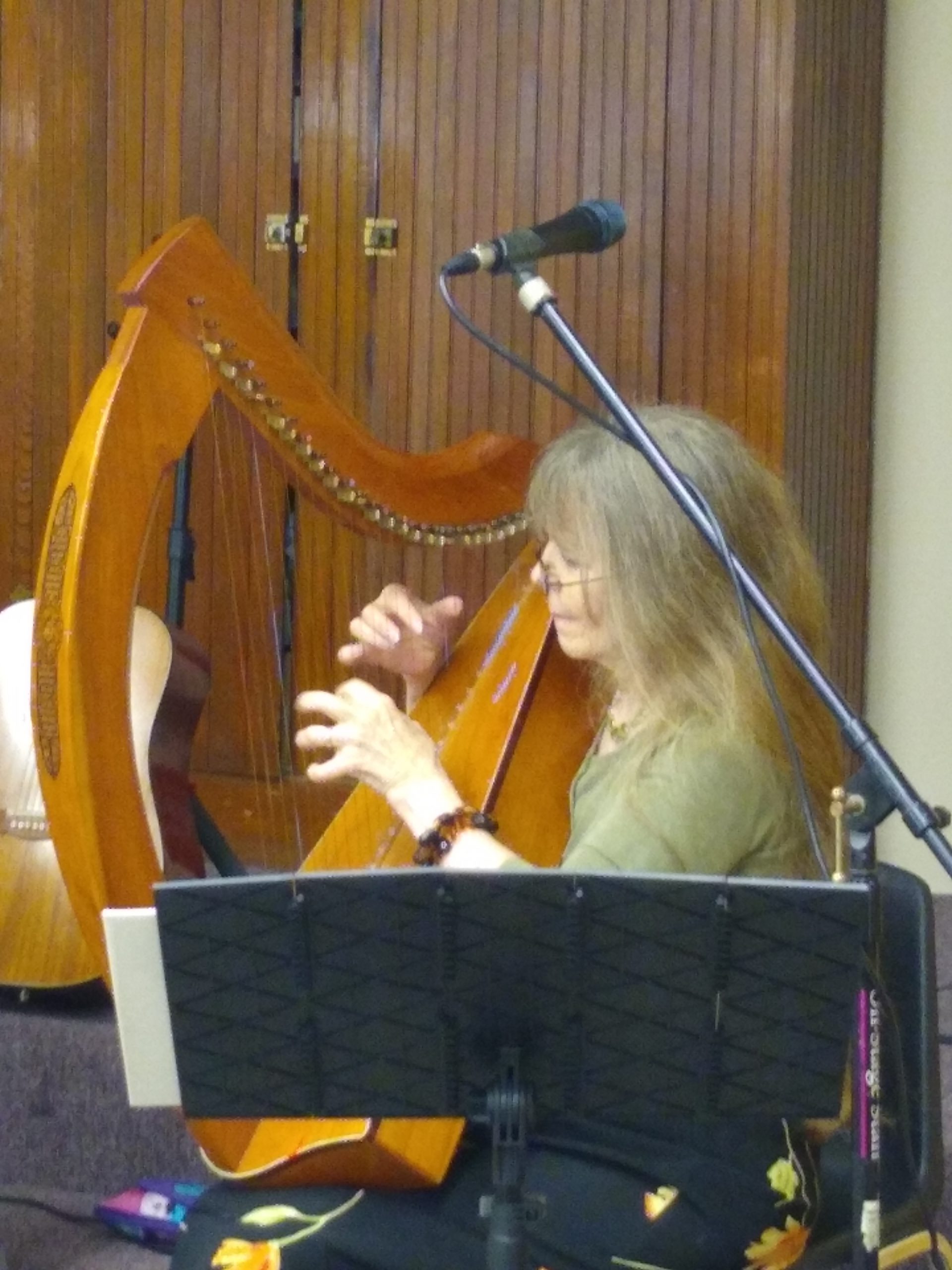 A woman plays a Celtic lap harp